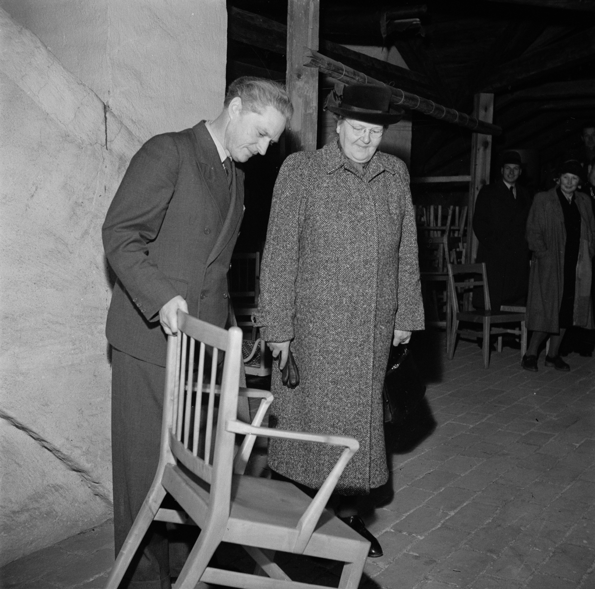 Fängelsedirektör F Karlström visar nämndledamoten Ingeborg Lundell en stol som tillverkats vid snickeriverkstaden på Uppsala ungdomsfängelse