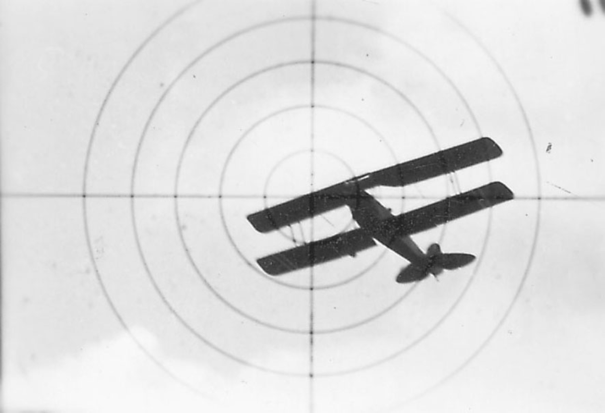 Luftfoto, ett fly i luften, sett gjennom våpensikte. I sikte Tiger Moth