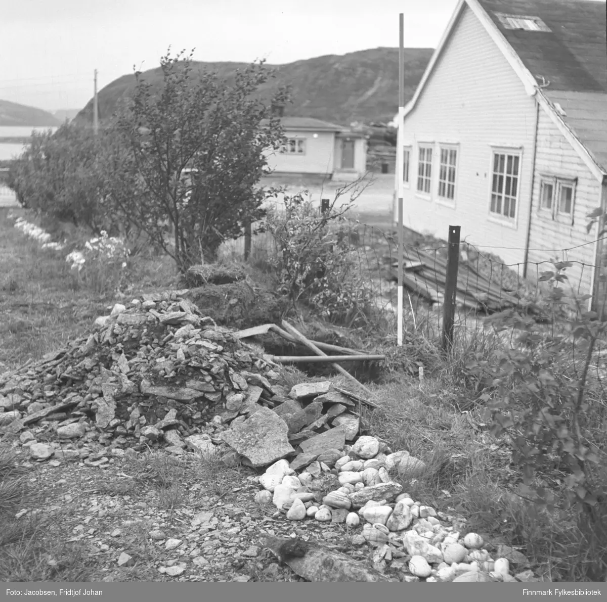 Graving av en vann/koakk-grøft på Arne Nakkens eiendom i Rypefjord. Bygget til høyre på bildet er Statens vegvesens lager. I bakgrunnen ses fjellet Rypefjell.