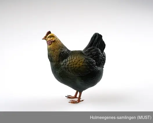 Lekedyr utformet som en høne, laget av celluloid med føtter av malt blikk.