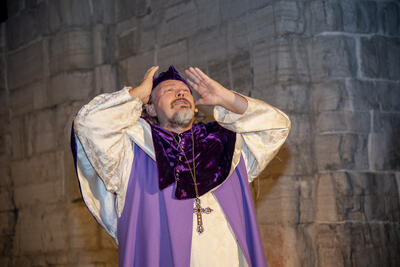 En fortvilet biskop Mogens holder hendene opp mot hodet.
