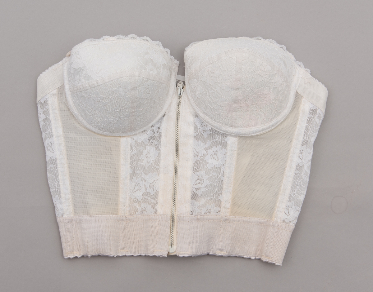 Stroppløs hvit brystholder med spiler. Glidelås og hemper i front. 1950-talls. Blondepynt. Merkelapp: "Loveable"