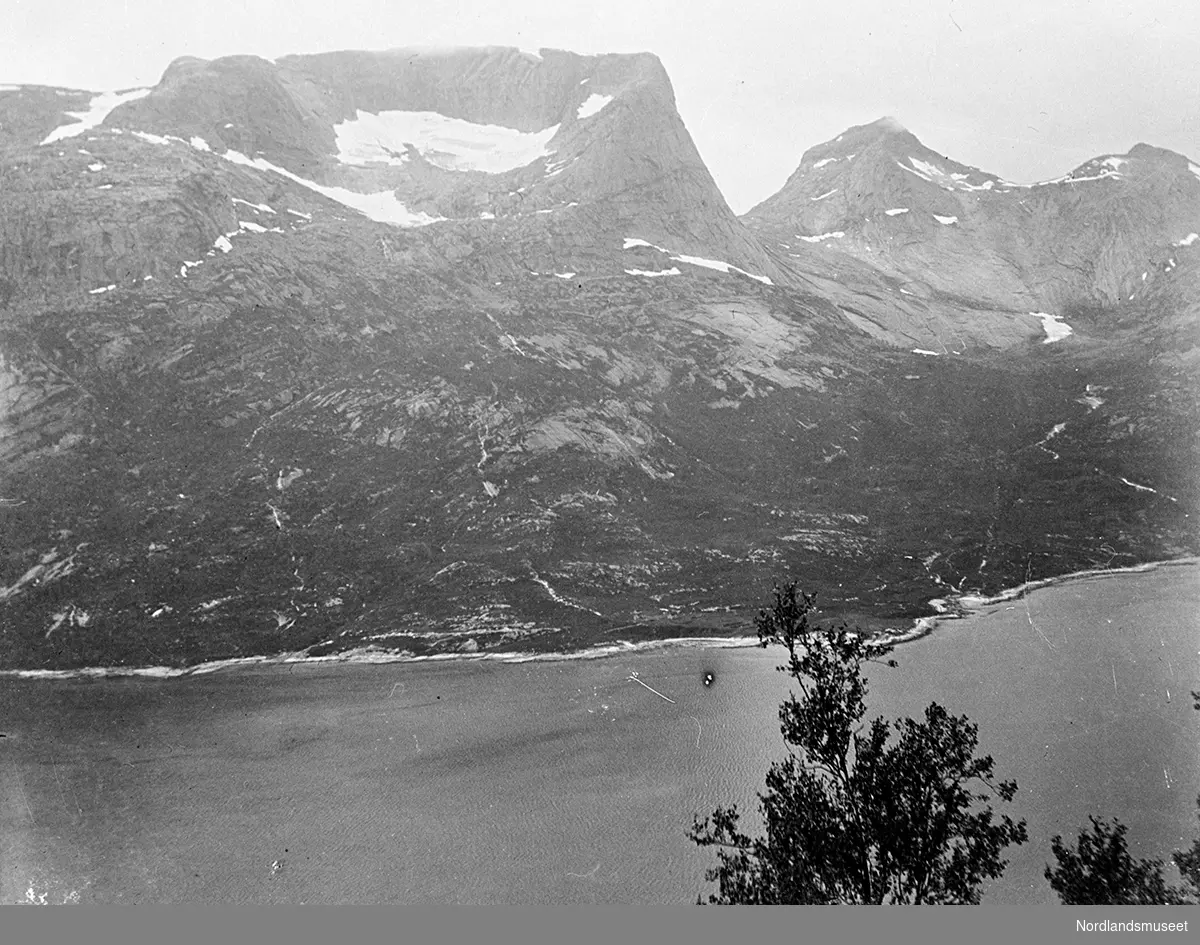 Fra Efjorden mot Konnemestind. Hav foran bratte fjell bak. Fotografen står oppe i "høyden" og fotograferer en del av fjorden og Kobbertind. Kobbertind er 1003 m.