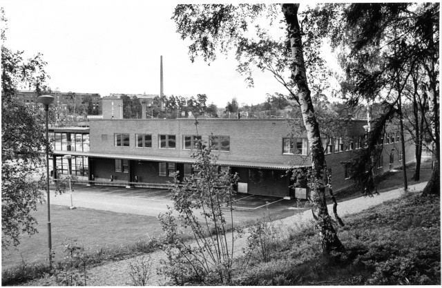 Postterminalens baksida- Lastbryggan skymtar t v. Utmed långsidan tak ...