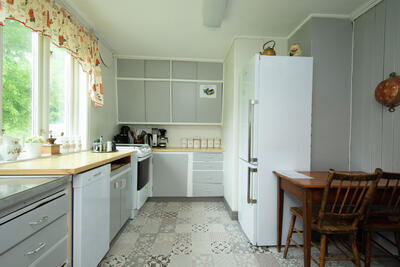 Kjøkkeninteriør i grått, med brunt trebord (Foto/Photo)