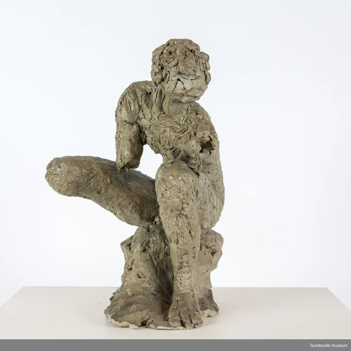 En skulptur i form av en sittande man.