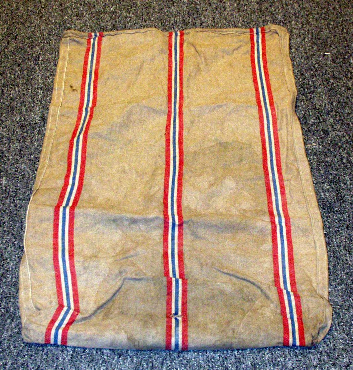 Postsekk i strie med norske striper, rødt, blått og hvitt.