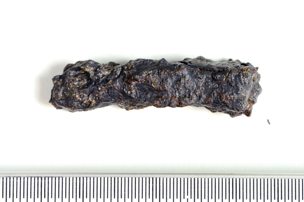 Ett fragment av jern funnet i lag 2 i S10214, en avfallsgrop i det som er tolket som et smieområde. Funnet er saltutvasket. 