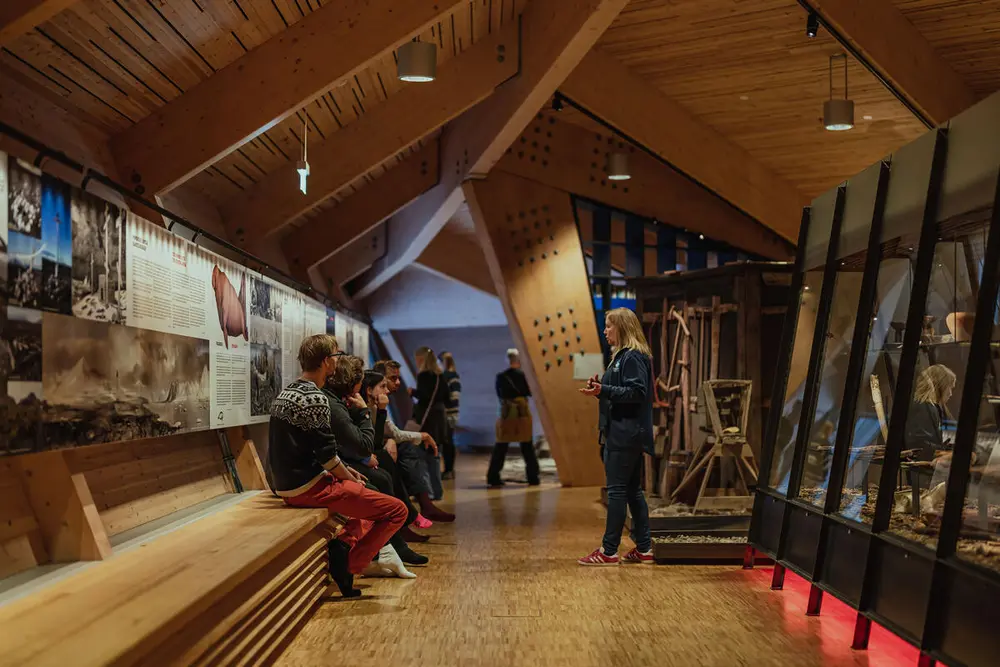 Photos shows a small group together with the museum guide.