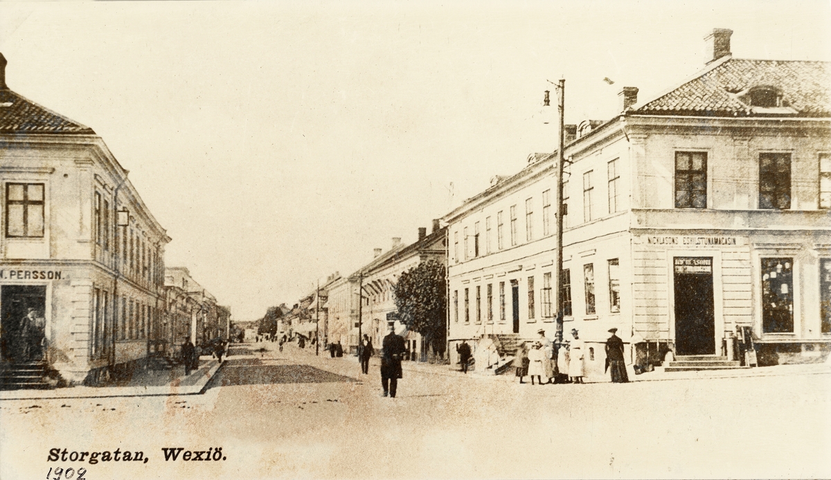 Storgatan i korsningen mot Kungsgatan, 1902. En polis patrullerar i mitten av gatan. Till vänster syns den då välkända 
"P.N. Perssons hörna".