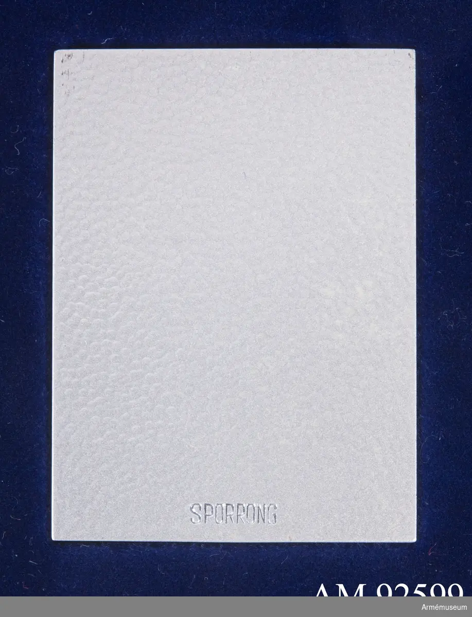 Plakett i silver för Arméstaben med inristat namn "B. von Braun". Plaketten är rektangulär med dekoration av tre kronor inom en krönt ordenskedja. Den ligger i en mörkblå plastask på en bädd av blå sammet.
