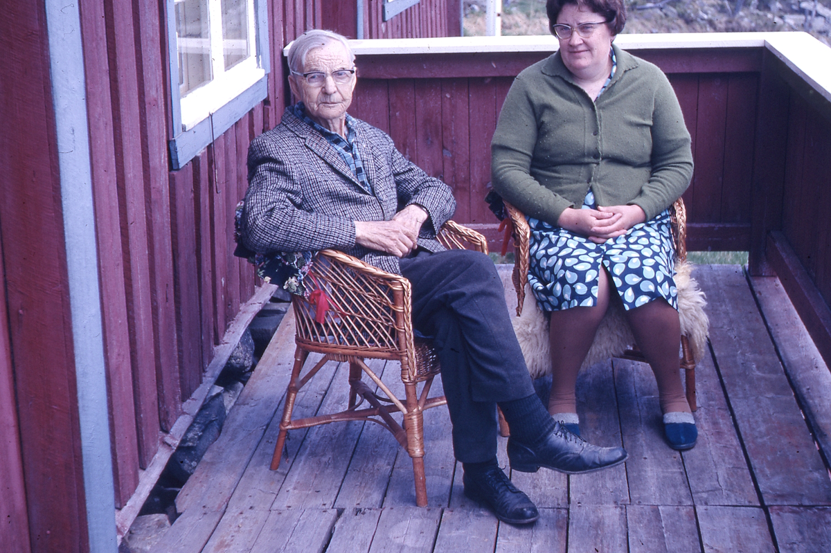 Esten Grastokk og Herdis Grastokk på verandaen på hytta på Grønhovd
