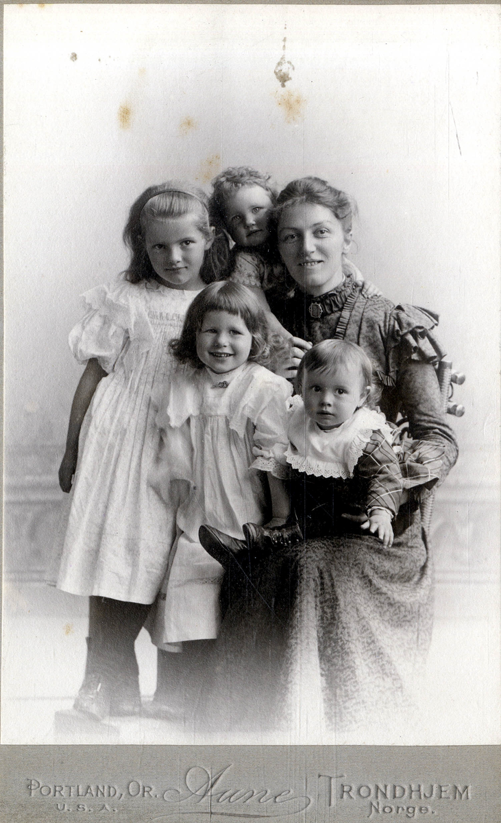 Gruppeportrett. Kvinne og fire barn.