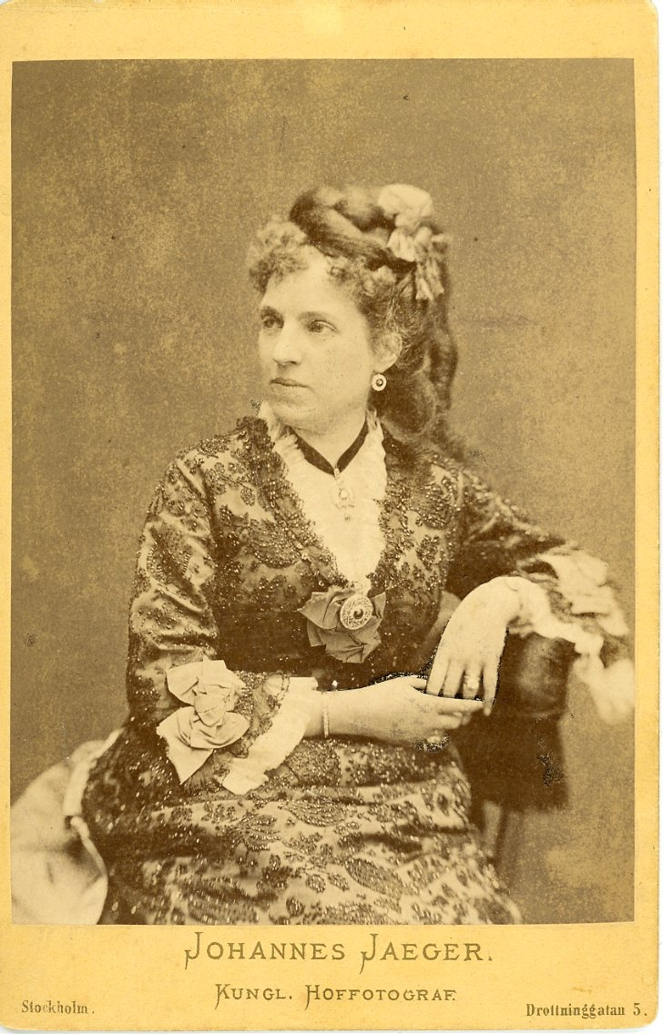 Porträtt av en okänd kvinna som sitter på en stol.