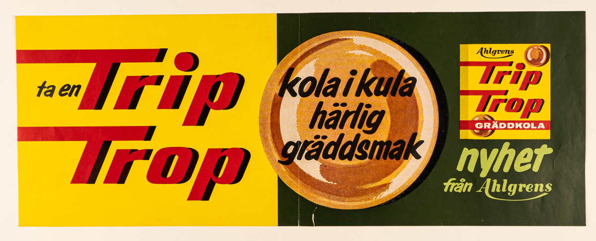 Reklamaffisch i papp, gul, svart med röd och svart text: "ta en Trip Trop kola i kula härlig gräddsmak nyhet från Ahlgrens".