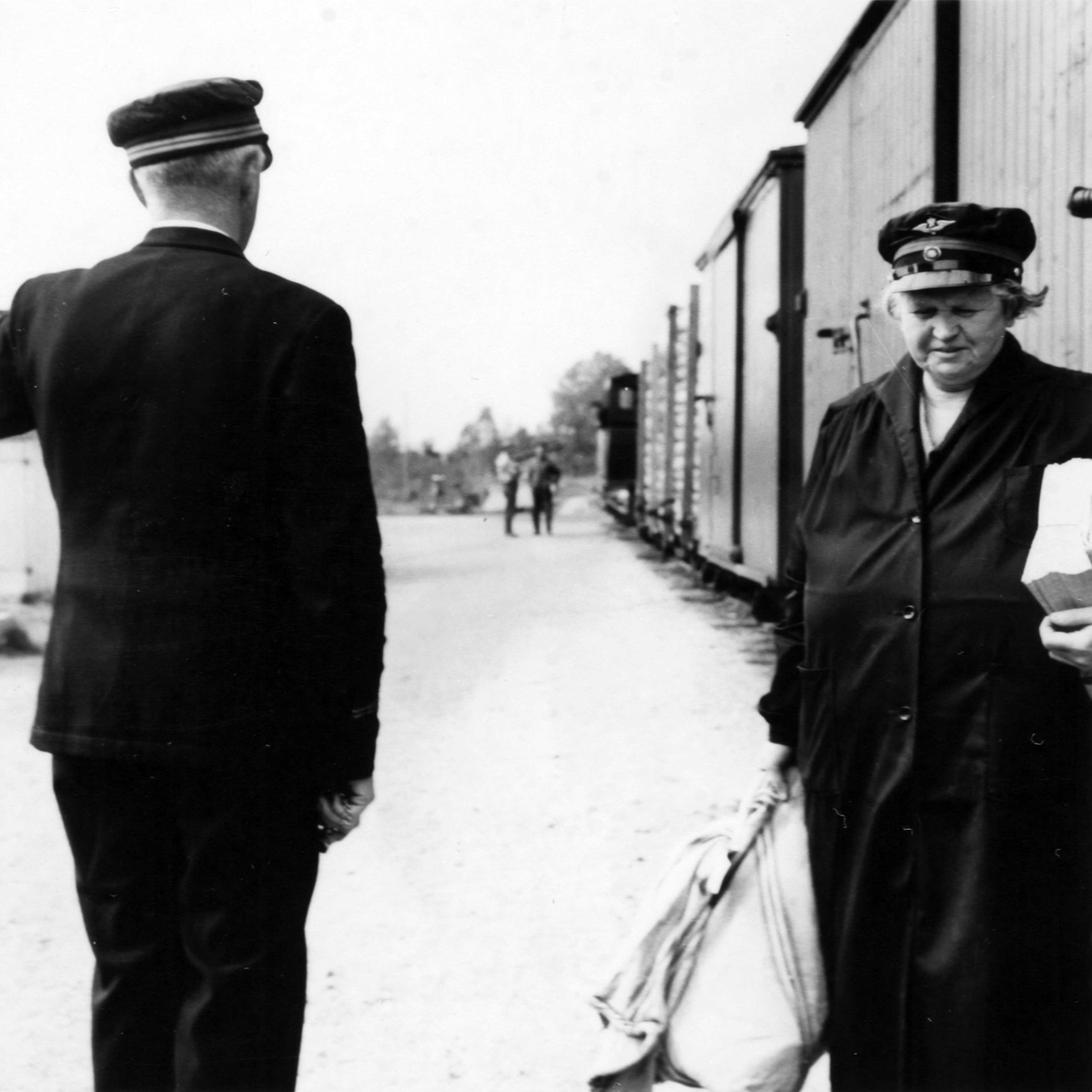 Stasjonsmester og overkonduktør utveksler meldinger under oppholdet på Hornåseng stasjon. Overlevering av dagens post.