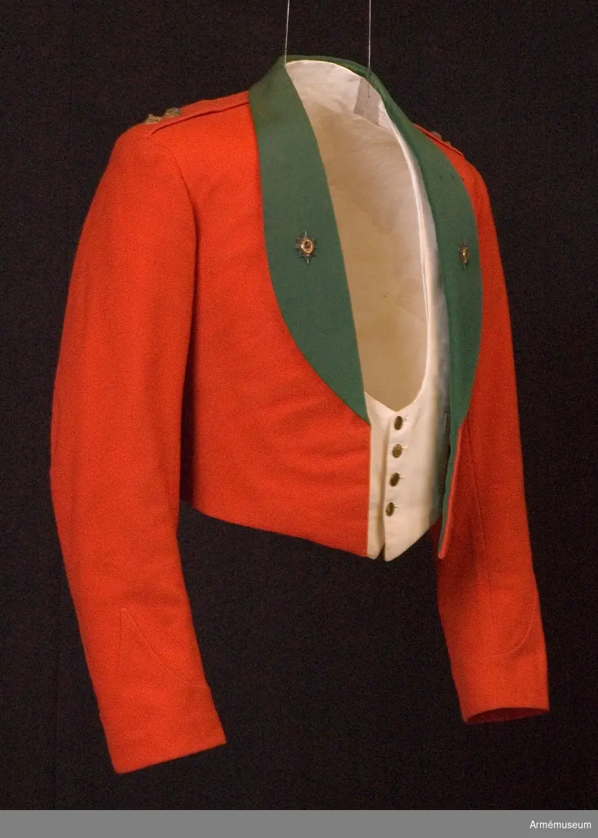 Grupp C I.
Del av mässuniform för överstelöjtnant vid The Worcesterhire Regiment i England: "scarlet shell jacket" med två regementsmärken.
Enligt "Dress regulations 1900" av W. Y. Carman fastställdes denna jacka 1896-07-17. 
Förmodad gåva från Lt Col P. H. Graves-Morris D.S.O. M.C.  Engelsk militärattaché i Sthlm.