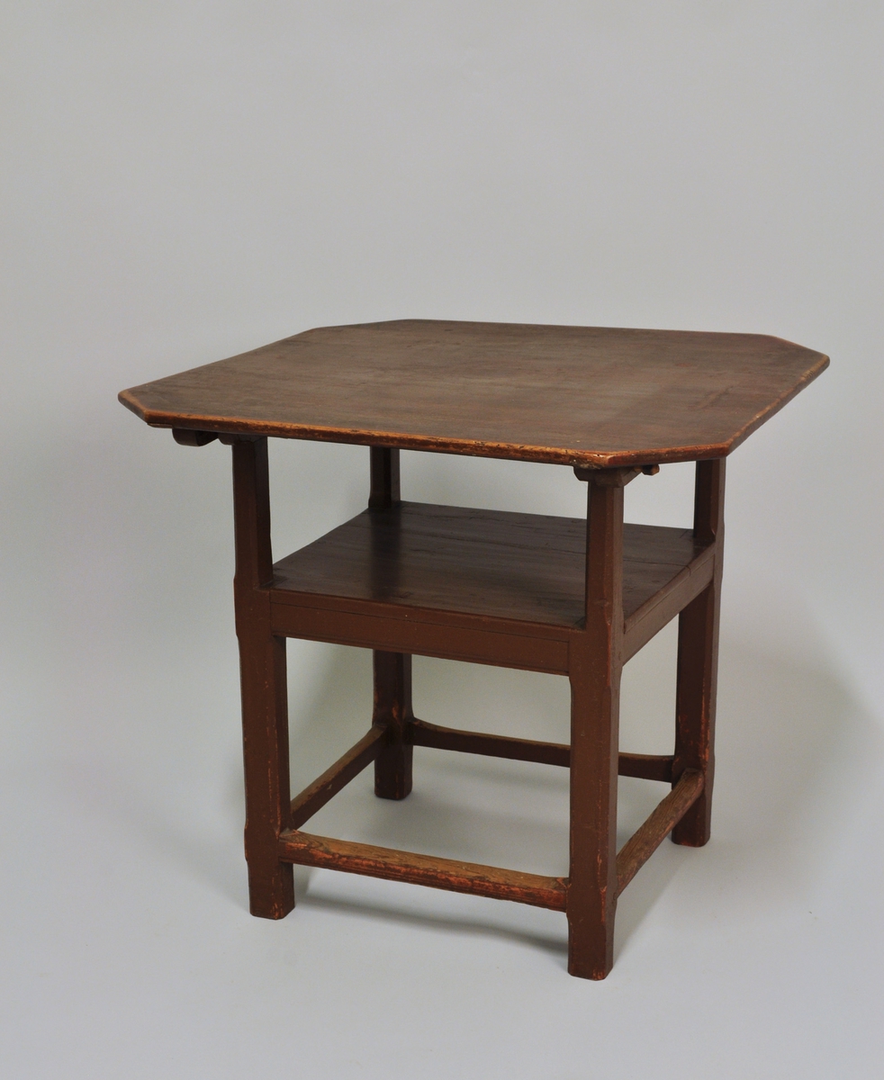 Fra protokoll: Bordstol av furu, einfeld form, plate med avkutta hjørne. Nyare pinnar i festehola. H. = 69,5, br. = 76 cm
