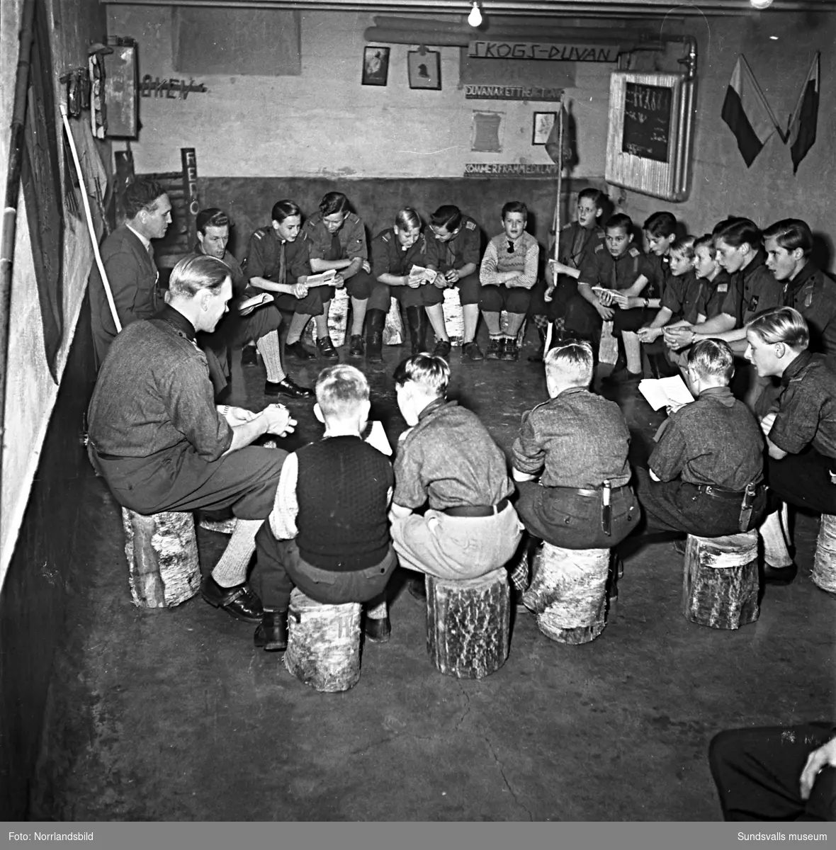 Frälsningsarméns scoutkår, pojkscouter och ledare i en källarlokal.