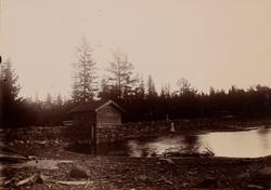 "Alunsjøen" Et lite laftet bygg langs en oppbygd vei ved Alu