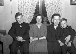 Trolig familieportrett. konfirmant med foreldre og lillebror