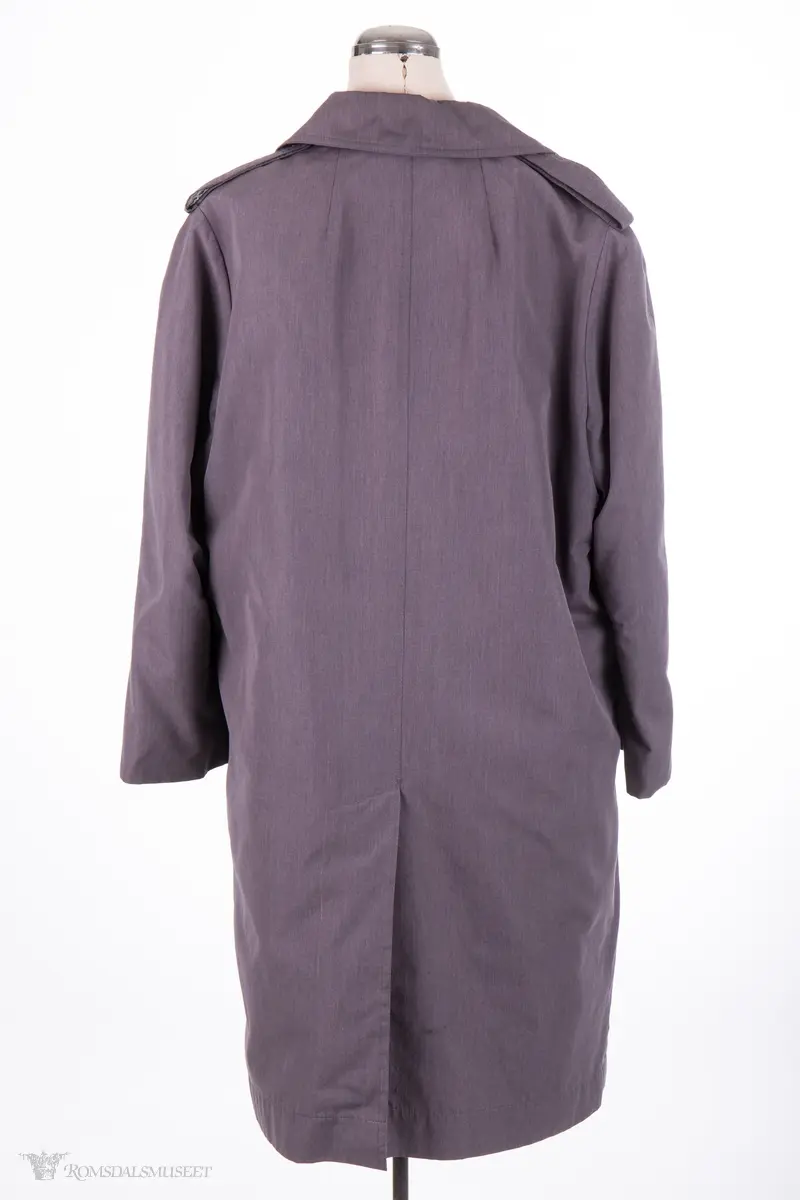 Rettskåret, moderat lengde, enkeltspent med 3 knapper, nedbrettet krage og slag, 2 sidelommer med klaff,uten lukning. Helforet med nylonstoff,påkneppbart teddyfor.