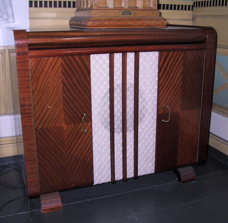 Kabinettet har to dører med rom for plater. Tekstil foran med åpning for lyd.