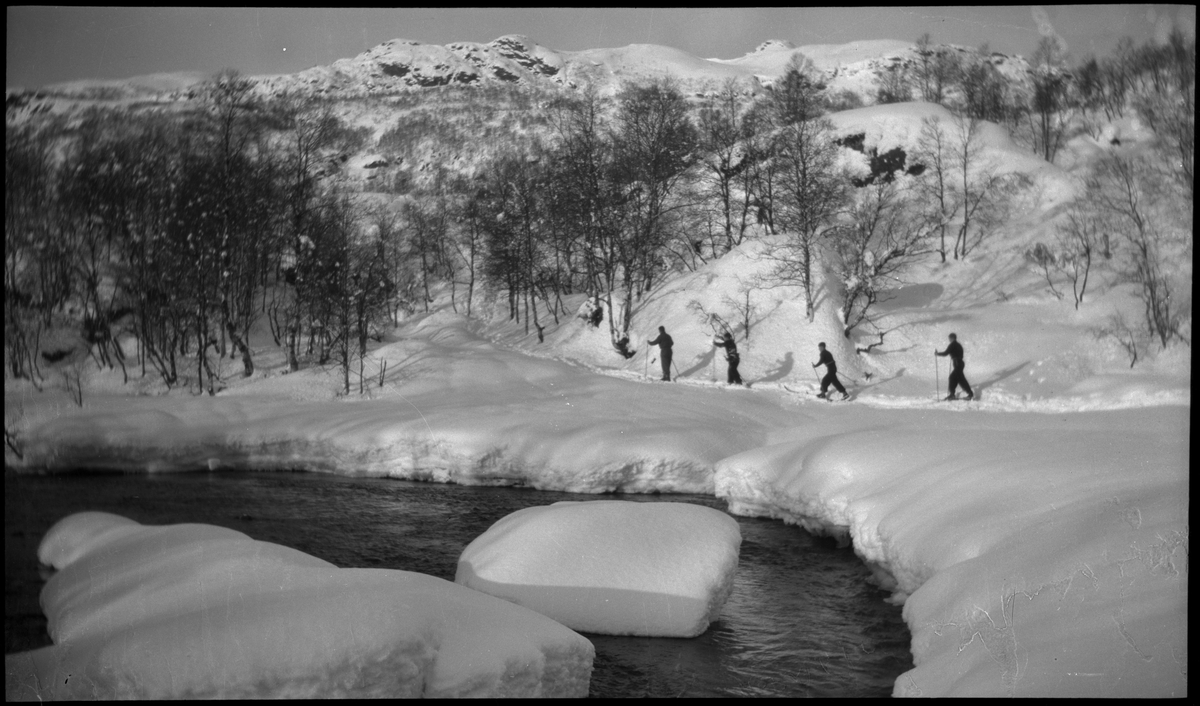 En vennegjeng på skitur i Suldal i vekslende vær. De er innom flere støler og overnattingshytter, bl.a. turistforeningshytta i Stranddalen. Noen ganger er klærne deres hvite av snø. Det er mye snø i fjellet og de må grave seg inn til hyttene. I den ene hytta lytter de til radio og studerer et gevær. Bilde nr. 6 viser en som smører skiene sine.
