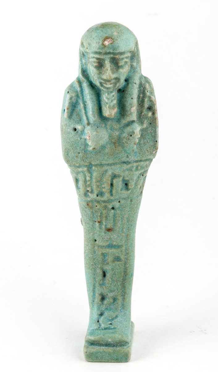 Figurer i form av egyptiska mumier, porslin, 2 stycken, grönblåfärg, en trasig.