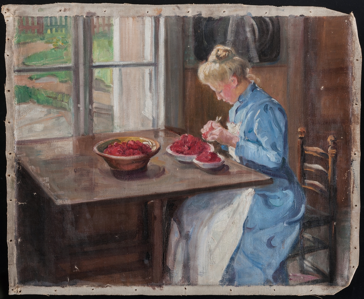 Oljemålning på duk utan spännram, föreställande kvinna som rensar bär, sittandes vid ett bord inomhus vid ett fönster. Målningen är inte signerad eller daterad.