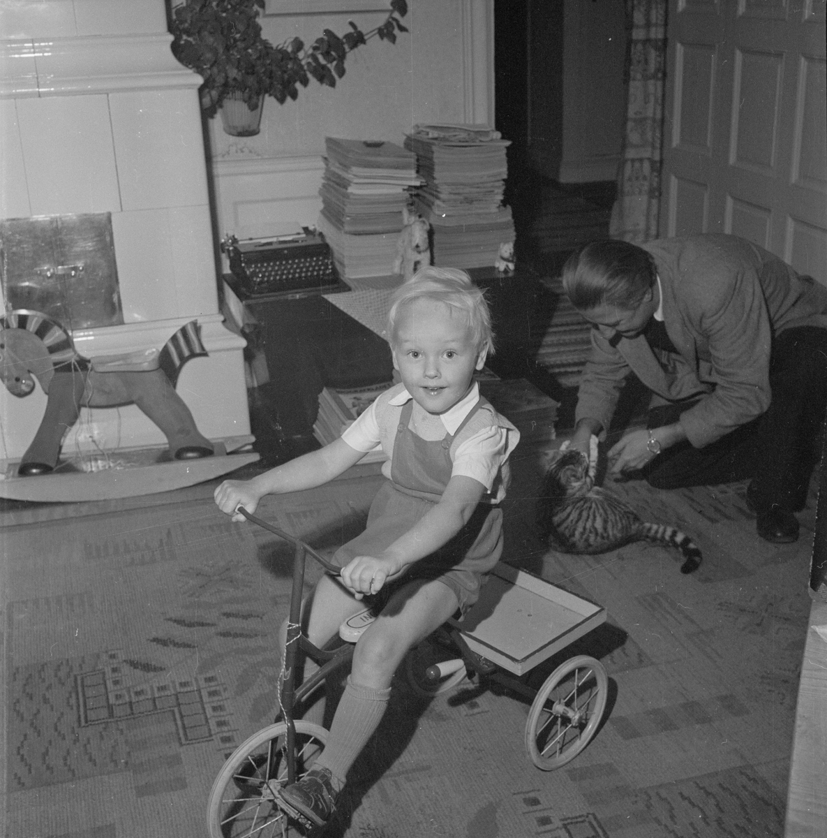 Hugo Wortzelius och sonen som sitter på trehjuling, Uppsala 1954