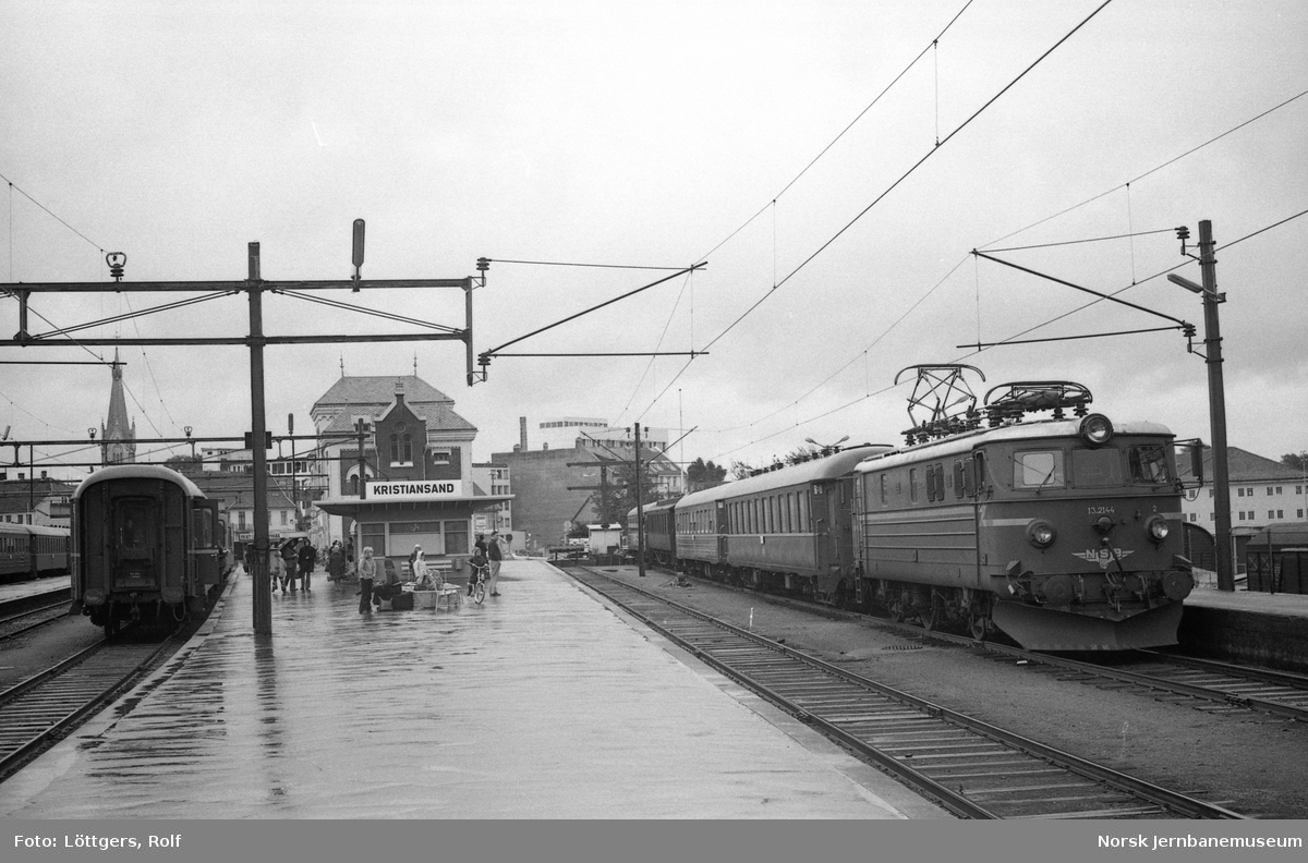 Elektrisk lokomotiv El 13 2144 med dagtoget fra Stavanger til Oslo V, tog 702, på Kristiansand stasjon. Ekstra vogner kobles til toget