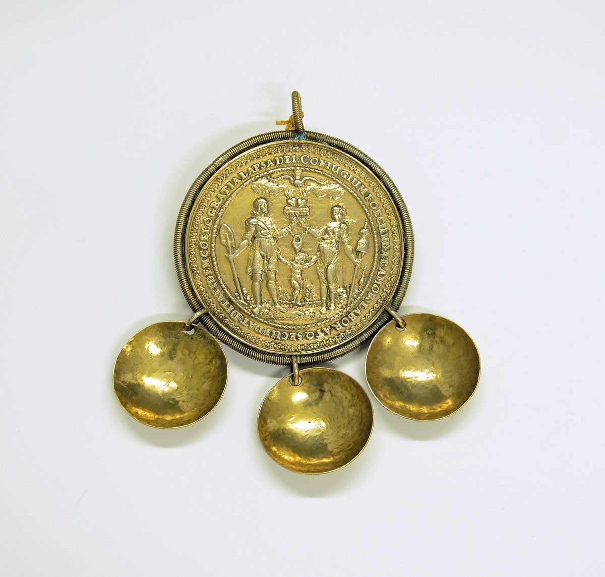 Brudedaler. Fra protokollen: Bryllypsmedalje, forgyldt, med 3 store skaaler, allegoriske fremstillinger og latinske indskrifter.