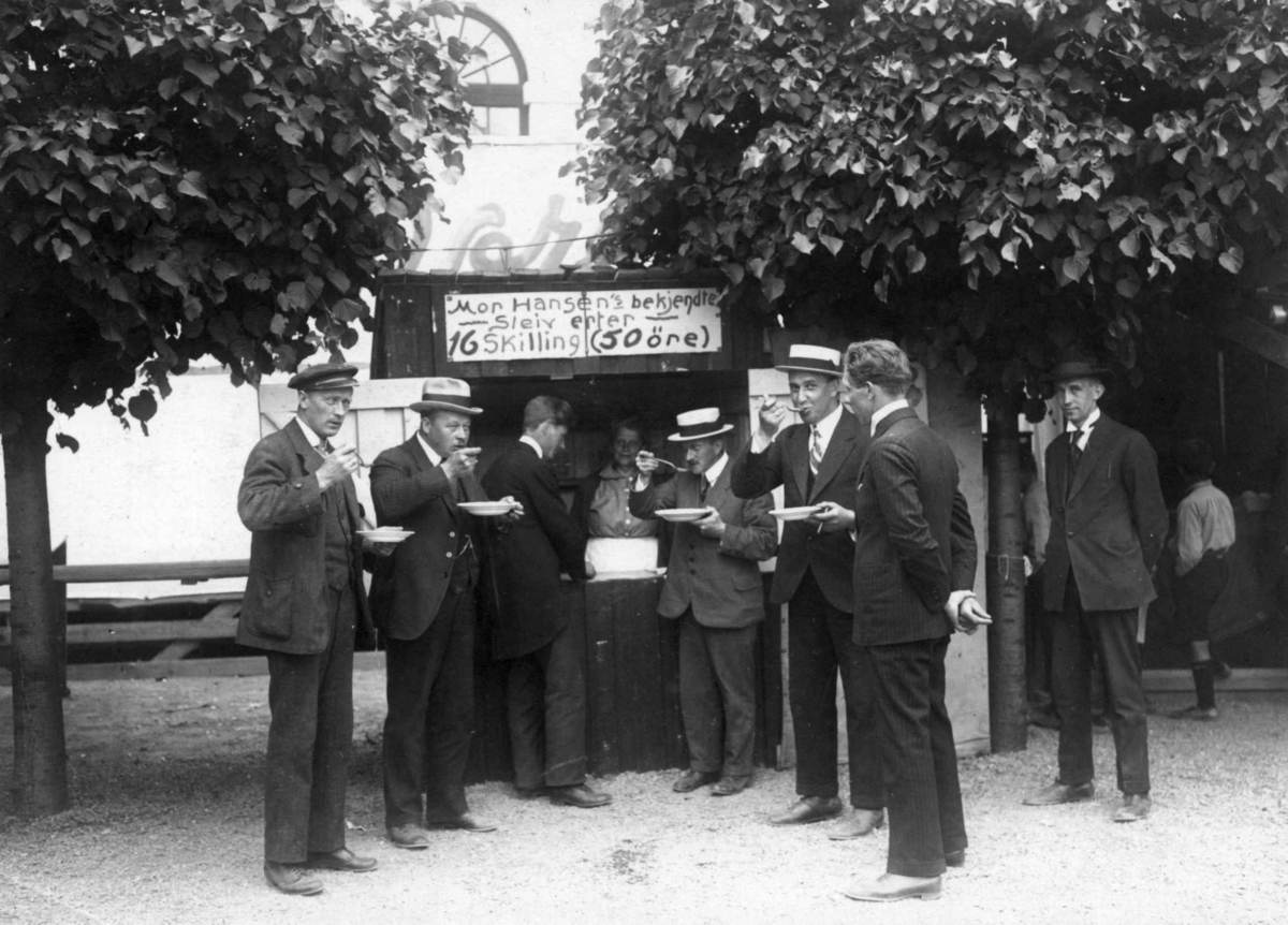 Menn foran salgsbod med mat på markedstilstelning i 1922 på Norsk Folkemuseum.