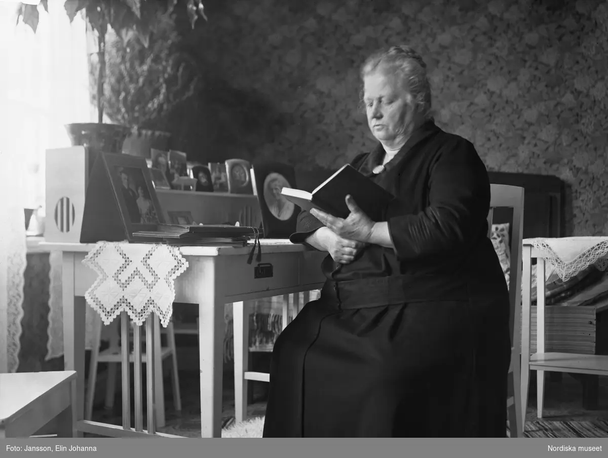 En äldre kvinna läser en bok. Lima, Dalarna.