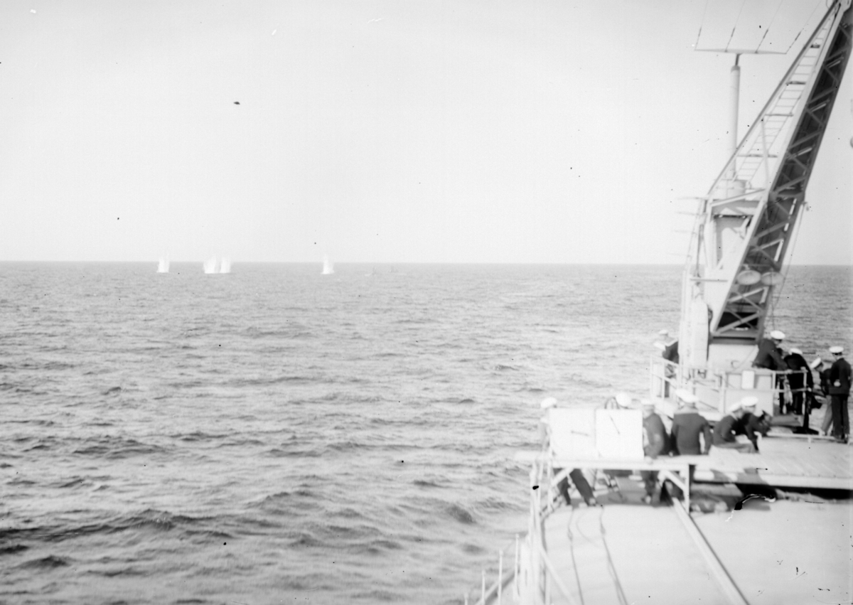 Torpedsprängning från fartyg till sjöss. Nedslag. I förgrunden syns ett fartyg med manskap.
