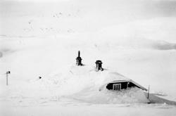 En nedsnødd Grjotrust vokterbolig vinteren 1948/49