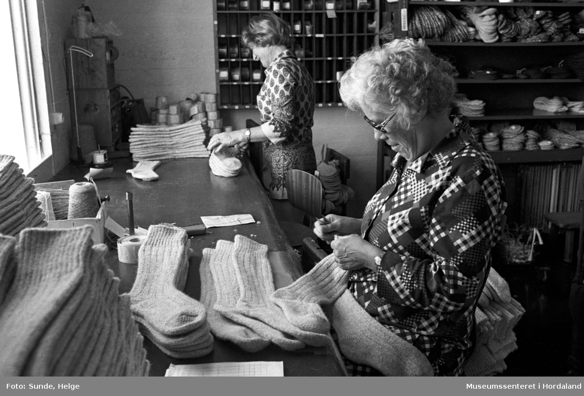 Arbeidsliv ved Salhus Tricotagefabrik i Salhus, Bergen i 1976. Samanlegging av sokkar.

F.v.: NN, Magda Sellevold.