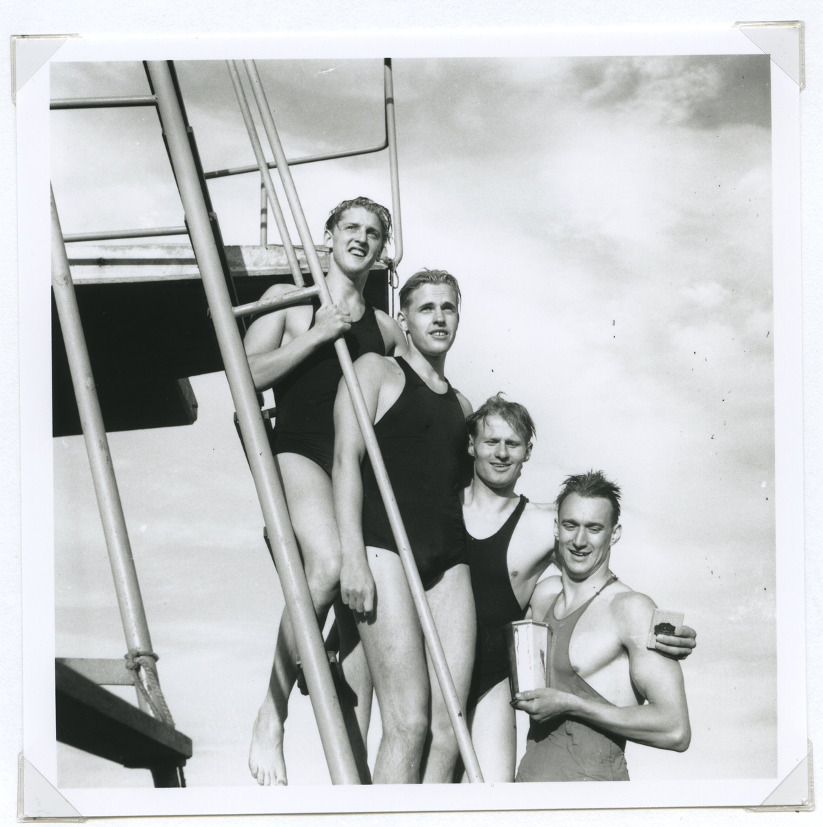 SM i simning vid Långviksbadet  2/8 1946. 

Per Olof Olsson håller Kalmarsundspokalen som erövrats av Hellas 4 x 100-meterssimmare.
 De övriga tre är: Harald Englund, Arne Jutner och Rune Gustavsson.