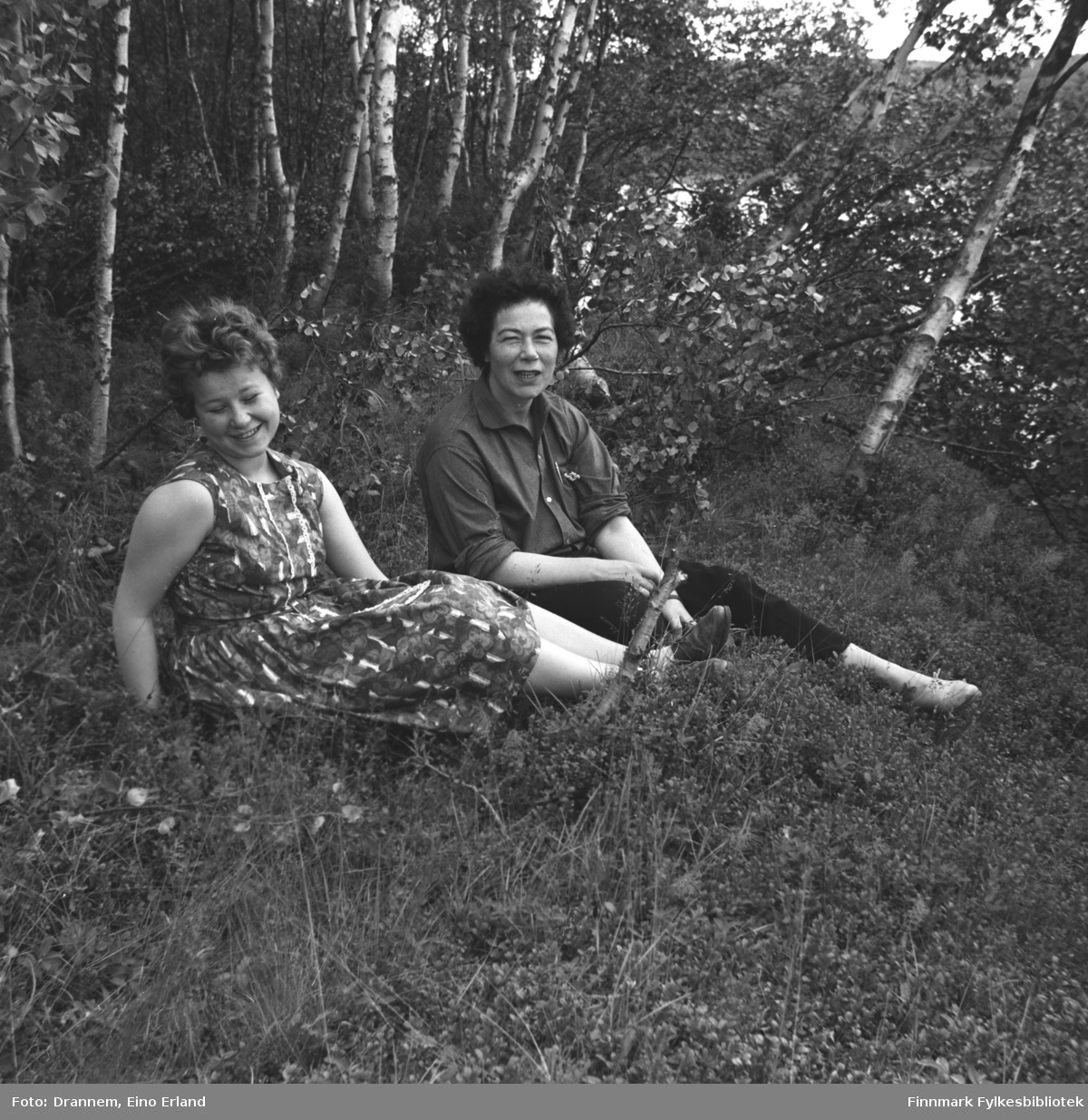 Turid og Jenny sitter i en lysning i skogen.