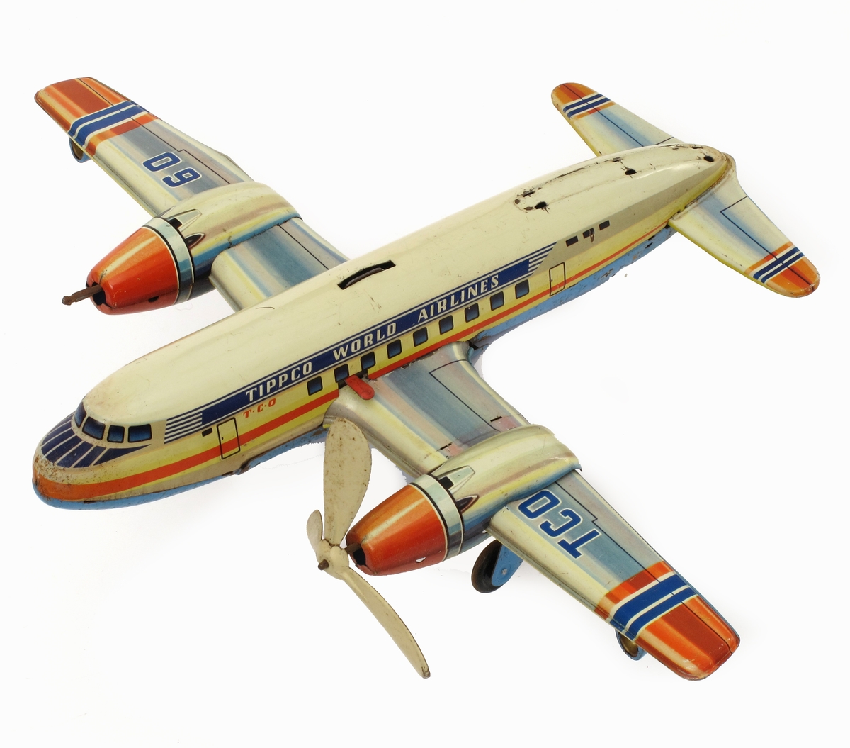 Lekefly, propellfly, passasjerfly, av jernblikk m.m. Med fjærmotor til opptrekking. Malt i blått, orange og gult.