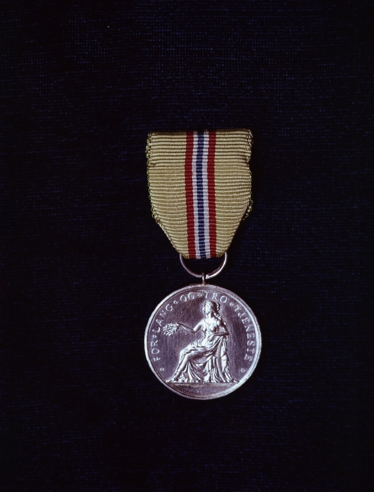 Nærbilde av Norges Vels Medalje for Lang og Tro Tjeneste