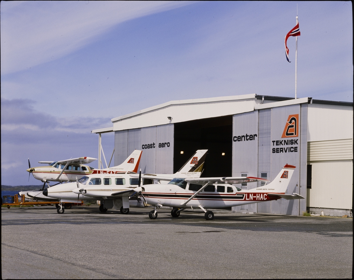 Tre fly står utenfor hangaren til "Coast Aero Center" på Haugesund Lufthavn, Helganes.