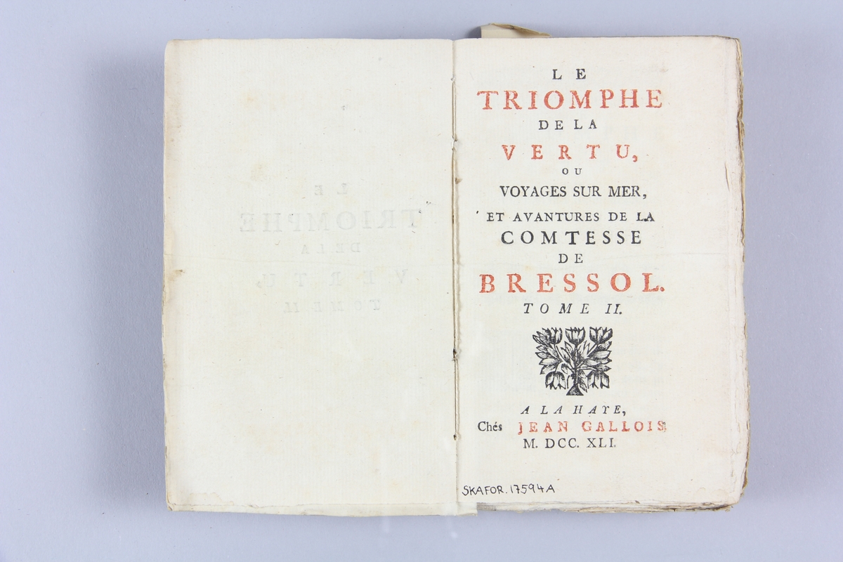 Bok, häftad "Le triomphe de la vertu", del 2, tryckt 1741 i Haag.
Pärm av marmorerat papper, oskuret snitt. På ryggen etikett med titel och samlingsnummer.
