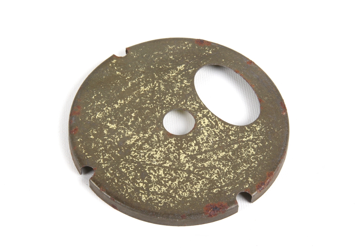 Sirkulær plate med en oval og en mindre sentrert sirkelform. Tilbehør til kjøttkvern.