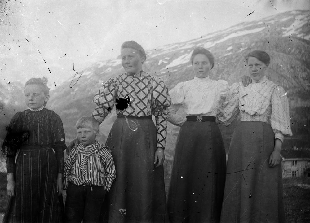 Leirfjord. Fem personer fotografert ute med fjell i bakgrunnen.