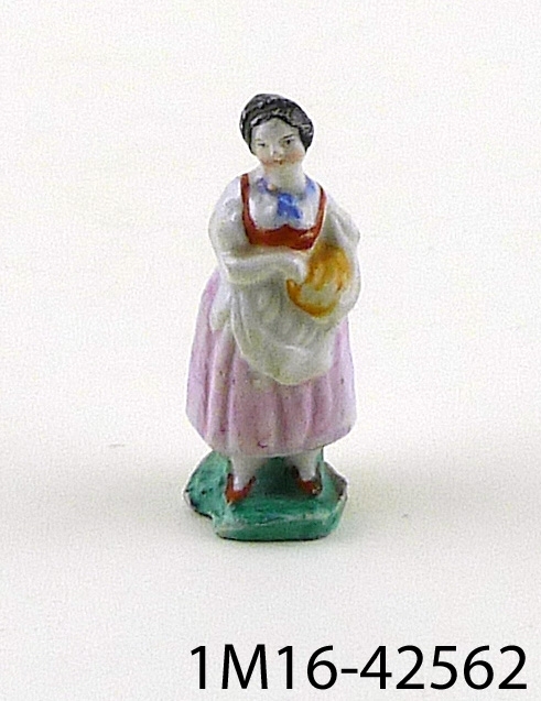Figurin föreställande stående kvinna.