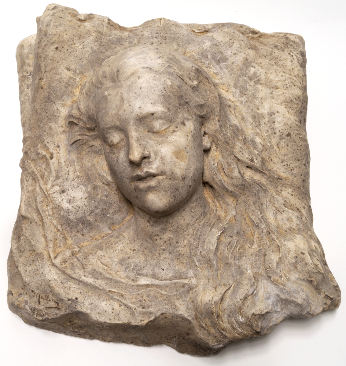 Skulptur, originalgips. Signerad Matton 1892, framsida, nedre högra hörn.
Kvinnoansikte med slutna ögon.