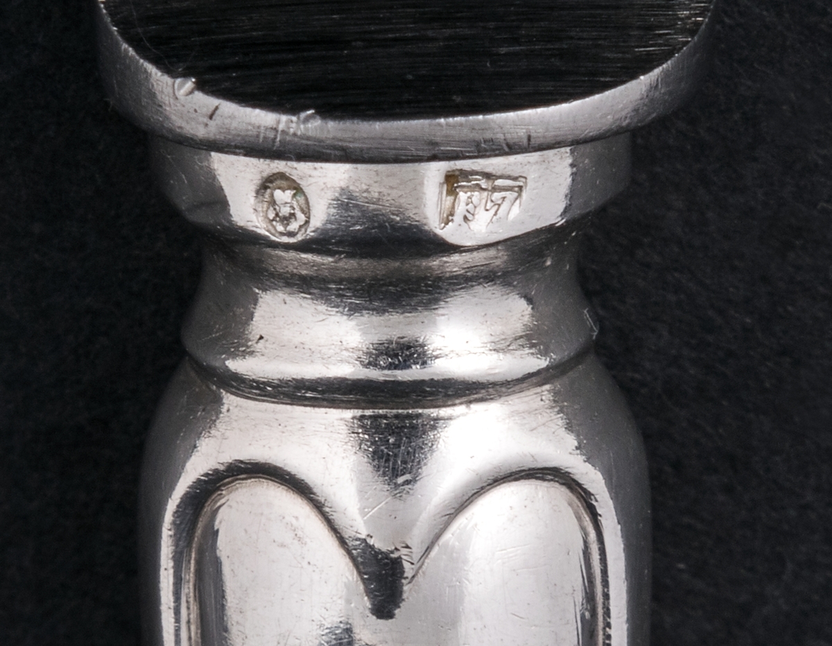 24 stycken matknivar av silver. Linjeartat ornament på skaftet. Gammelfransk modell.
Stämplad: GM F7 Kontrollstämpel, Sthlm.

Monogram: PE