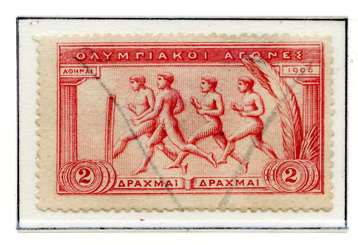 14 frimerker montert på en A4-albumside. Frimerkene har motiver fra de antikke klassiske lekene, tekstet med greske bokstaver.
